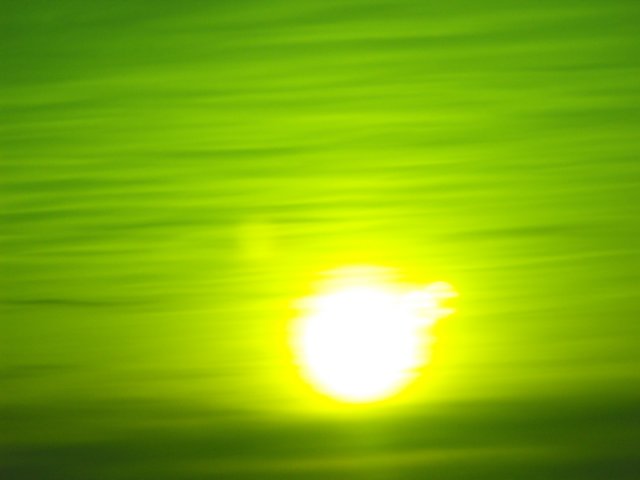 sunandstripeycloudsthroughthefilterglass.jpg