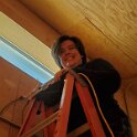 Darby using a ladder to put up a camera